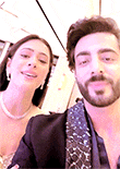 a man and a woman are posing for a picture .