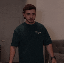 a man wearing a green shirt that says internet made on it