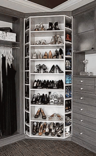 Gif of a large walk-in closet with a massive spinning shelf of dozens of shoes.