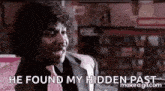 a man in a suit and tie is saying `` he found my hidden past '' in a store .