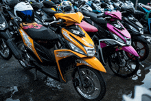 a row of motorcycles are parked in a parking lot one of which has the number b3 on the front