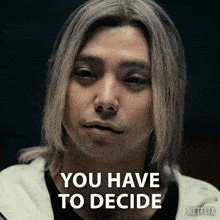 a man with long blonde hair says you have to decide on netflix