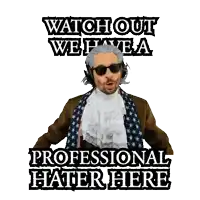 a man wearing headphones and a scarf with the words watch out we have a professional hater here behind him