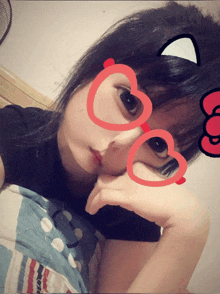 a girl wearing heart shaped glasses and a cat ear on her head