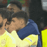 a group of soccer players are hugging each other with a da zn logo in the background