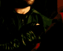 a close up of a man 's face with a black jacket on