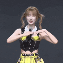 a woman in a plaid skirt is holding a microphone