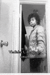 a black and white photo of a young boy standing in a doorway with vladislav urbanites seraph written on the bottom