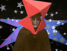 a man wearing a red hat and a black cape with stars in the background