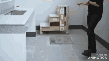a person standing in a room with the words made in animatica on the floor