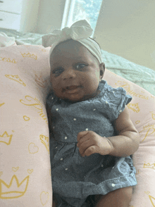 a baby is laying on a pillow that says princess on it