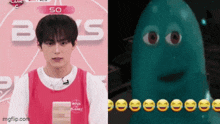 a man in a pink tank top next to a cartoon character with smiley faces .