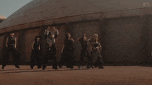 a group of people are dancing in front of a building with the letters s2 on it