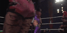 a woman in a wrestling ring with the number 6