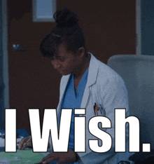 a woman in a lab coat sits at a desk with the words i wish