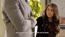 a woman in a suit talks to another woman who says hey maybe you shouldn 't work out so hard