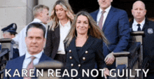 a group of people standing in front of a building with the words karen read not guilty written on the bottom