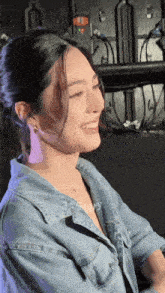 a woman wearing a denim shirt is smiling with the word story on the bottom