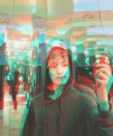 a man in a hoodie takes a picture of himself