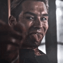 a close up of a man with his tongue hanging out
