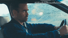 a man is driving a car with #abigbold beautiful journey written on the bottom