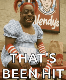 a wendy 's sign is behind a woman in a dress