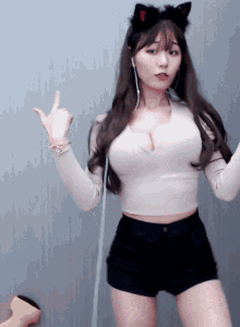a woman with a cat ear headband is dancing