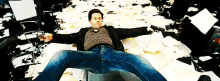 a man is laying on the floor with his arms outstretched holding a gun