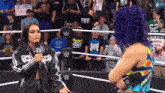 two women in a wrestling ring with a sign that says respect public