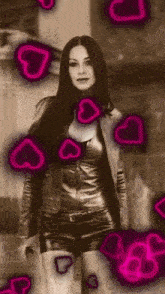 a woman in a leather jacket and shorts is surrounded by neon hearts