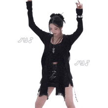 a woman in a black outfit is dancing in front of a white background with the word sus written on it