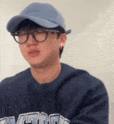 a man wearing glasses and a baseball cap is wearing a sweatshirt that says ' chicago ' on it