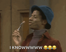 a man wearing a blue hat is holding a fork and says i knowwww