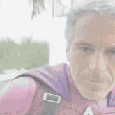 a man in a pink and purple superhero costume