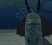a cartoon character from spongebob squarepants is looking at the camera while standing in the water .