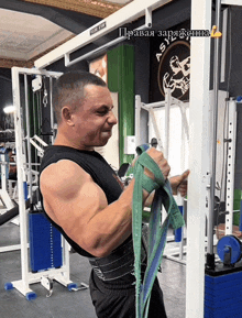 a man is working out in a gym with a sign that says asia