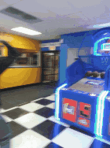 a person is playing a basketball game in a room with a checkered floor