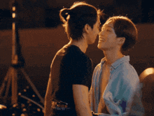 two men are hugging each other and looking at each other .
