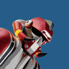 a red and white robot with horns and a mask