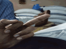 a person 's hand is giving the middle finger sign