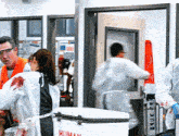 a group of people are standing around a cooler that says human on it
