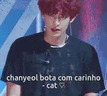 a man with red hair is wearing a black shirt that says " chanyeol bota com carinho - cat "