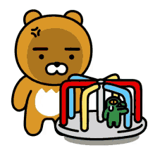 a brown teddy bear is standing next to a merry go round