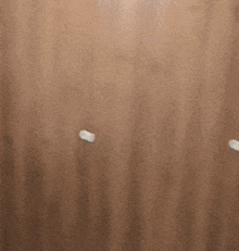 a blurred image of a door with a white handle on it