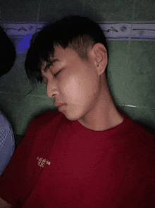 a young man wearing a red t-shirt with the word jojo on it