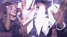 a man and a woman are dancing in a club and the woman is covering her eyes with a napkin