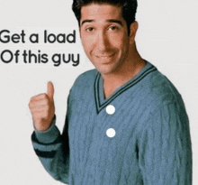 a man in a blue sweater is giving a thumbs up with the words get a load of this guy behind him