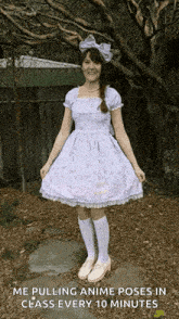a girl in a purple dress stands in front of a tree