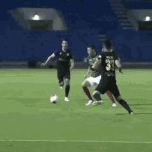 a group of soccer players are playing soccer on a field .