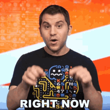 a man wearing a black shirt with a pac man on it says right now
